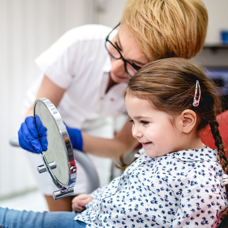 Dentist with young girl