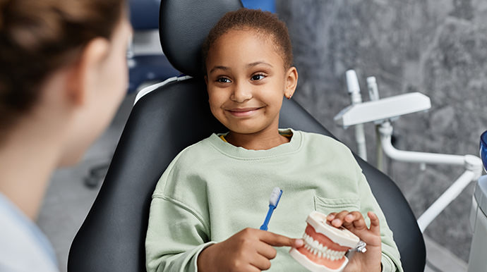 Dentist talking to a child patient