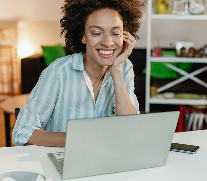 Smiling woman looking at laptop