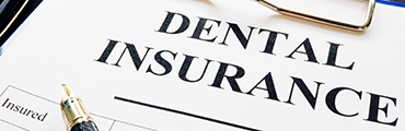 Dental insurance form and pen